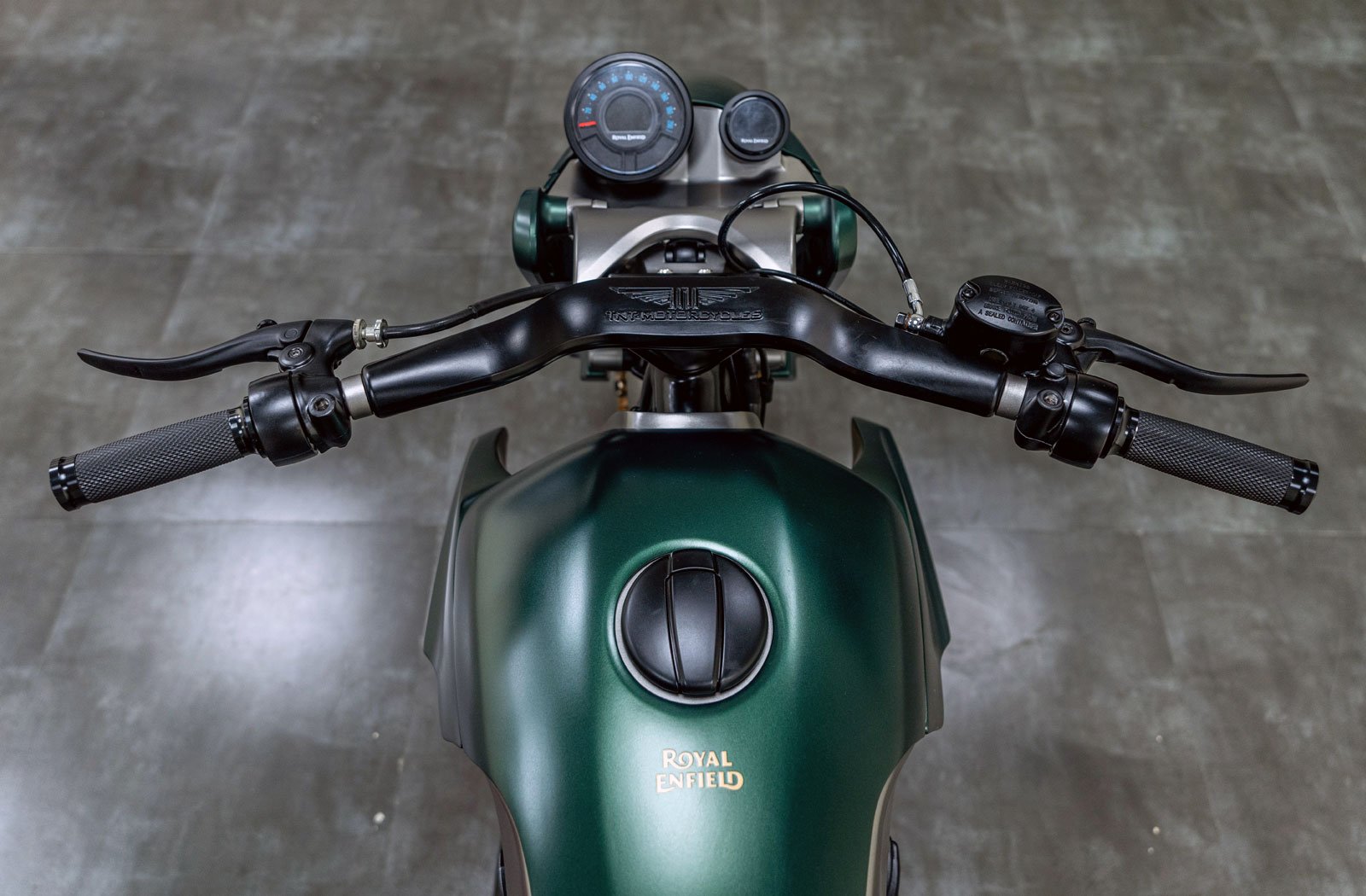 rider's view photograph of a custom Royal Enfield Shotgun 650 motorcycle fuel tank and handlebar